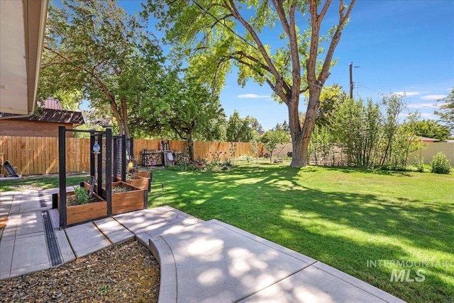 539 Rimview Dr, Twin Falls, ID 83301 - fenced backyard featuring a vegetable garden