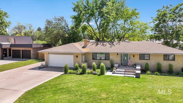 539 Rimview Dr, Twin Falls, ID 83301 - single story home with a garage, a front lawn, driveway, a chimney, and brick siding