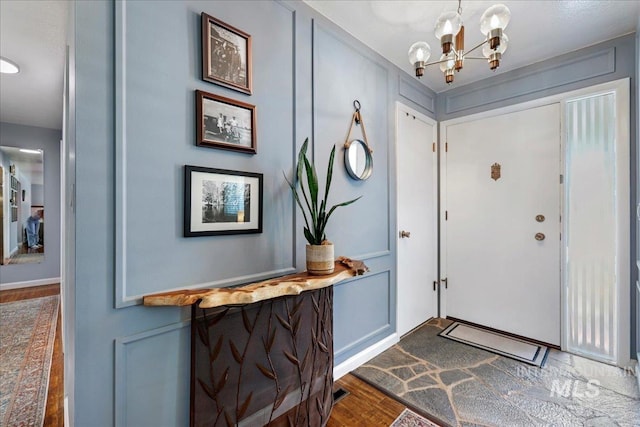 539 Rimview Dr, Twin Falls, ID 83301 - foyer entrance featuring dark wood finished floors and a chandelier