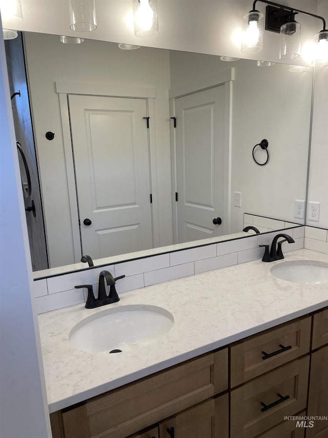 bathroom featuring double vanity and a sink