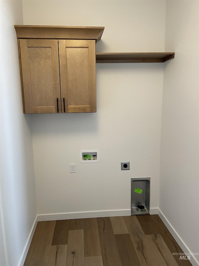 clothes washing area featuring baseboards, laundry area, hookup for a washing machine, electric dryer hookup, and dark wood-style flooring