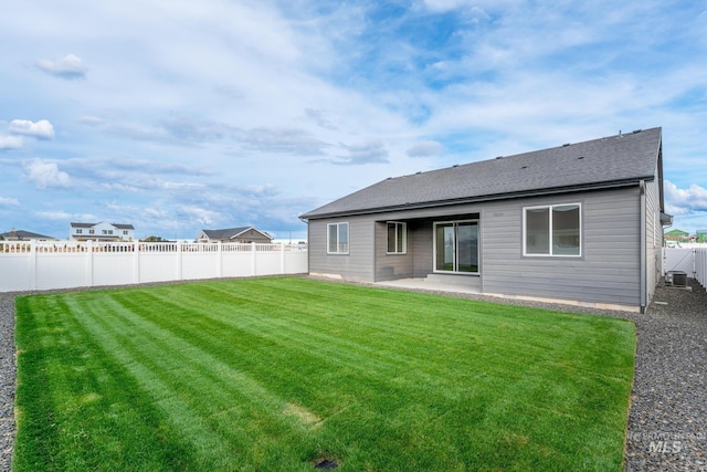 5485 N Patimos Ave, Meridian, ID 83646 - back of house featuring a fenced backyard, a shingled roof, a lawn, and a patio area