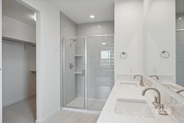 5485 N Patimos Ave, Meridian, ID 83646 - full bath with double vanity, a sink, a spacious closet, and a shower stall