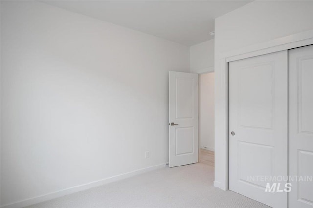 5485 N Patimos Ave, Meridian, ID 83646 - unfurnished bedroom featuring baseboards, a closet, and light colored carpet