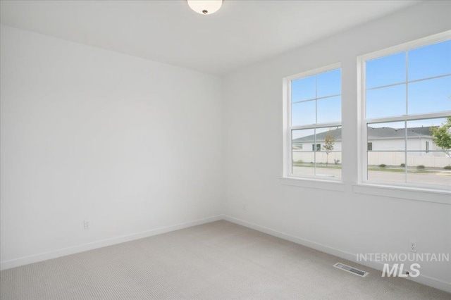 5485 N Patimos Ave, Meridian, ID 83646 - unfurnished room with baseboards, light carpet, and visible vents
