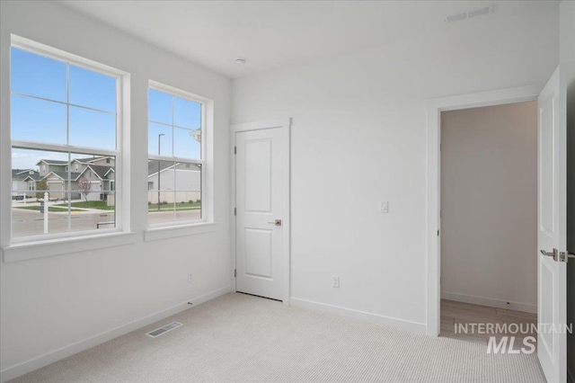 5485 N Patimos Ave, Meridian, ID 83646 - unfurnished bedroom featuring carpet flooring, baseboards, and visible vents