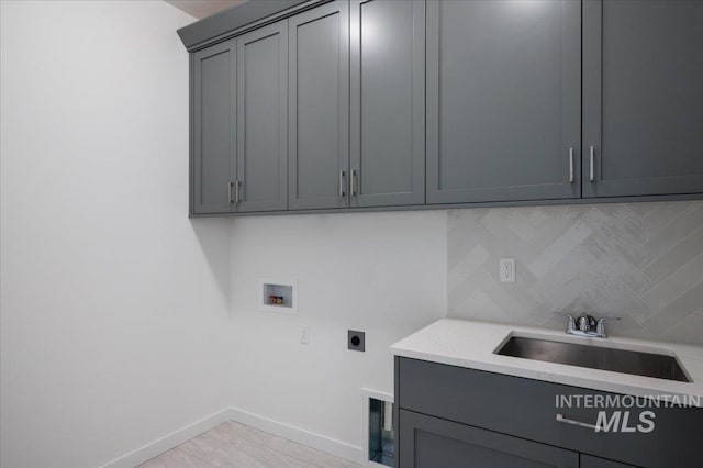 5485 N Patimos Ave, Meridian, ID 83646 - clothes washing area with cabinet space, washer hookup, a sink, baseboards, and hookup for an electric dryer