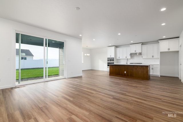 5485 N Patimos Ave, Meridian, ID 83646 - unfurnished living room with recessed lighting, baseboards, and wood finished floors