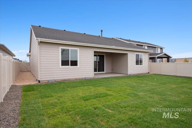 5485 N Patimos Ave, Meridian, ID 83646 - back of property featuring a lawn, a patio, and a fenced backyard