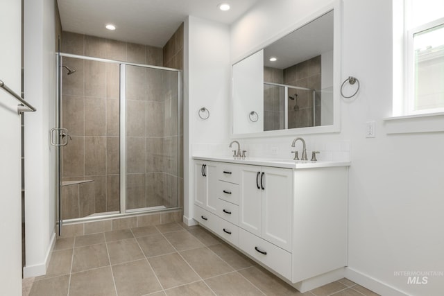 5485 N Patimos Ave, Meridian, ID 83646 - bathroom featuring a sink, baseboards, a stall shower, and tile patterned floors