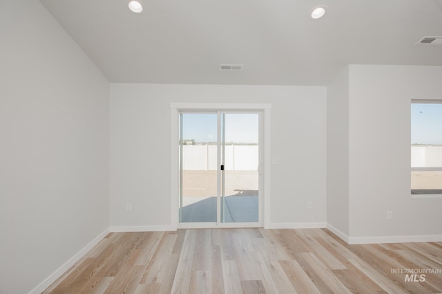 spare room with light wood-style floors, baseboards, visible vents, and recessed lighting