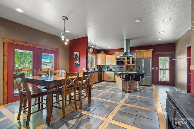 dining room with french doors and a textured ceiling