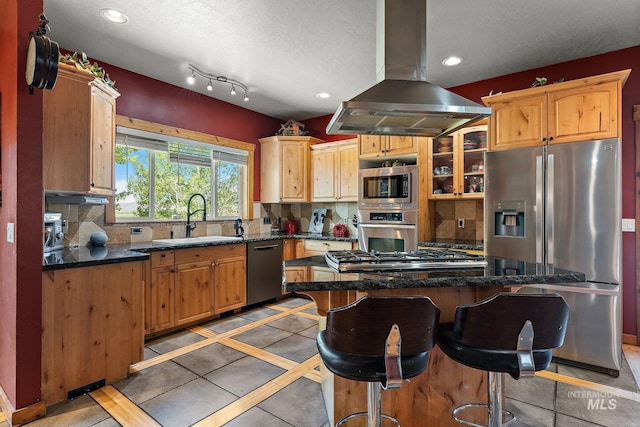 kitchen with a textured ceiling, island range hood, stainless steel appliances, sink, and light tile patterned flooring