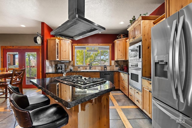 kitchen with a kitchen bar, plenty of natural light, stainless steel appliances, and island exhaust hood