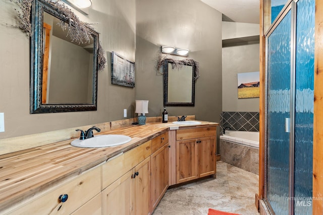 bathroom featuring vanity and separate shower and tub