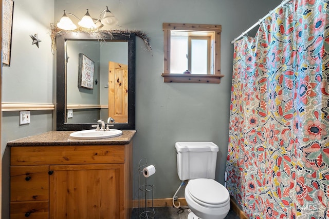 bathroom featuring vanity, toilet, a shower with curtain, and tile patterned floors