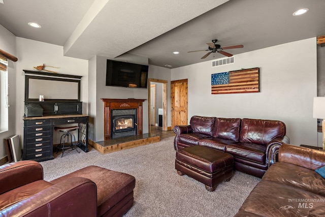 carpeted living room featuring ceiling fan