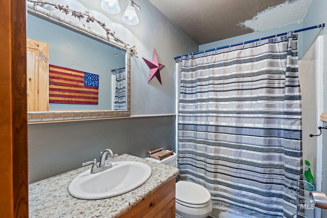 bathroom with a shower with curtain, toilet, a textured ceiling, and vanity