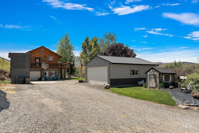 view of property exterior with a garage and an outbuilding