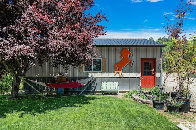 rear view of house featuring a lawn