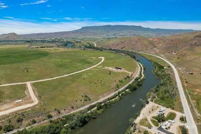 drone / aerial view featuring a water and mountain view and a rural view