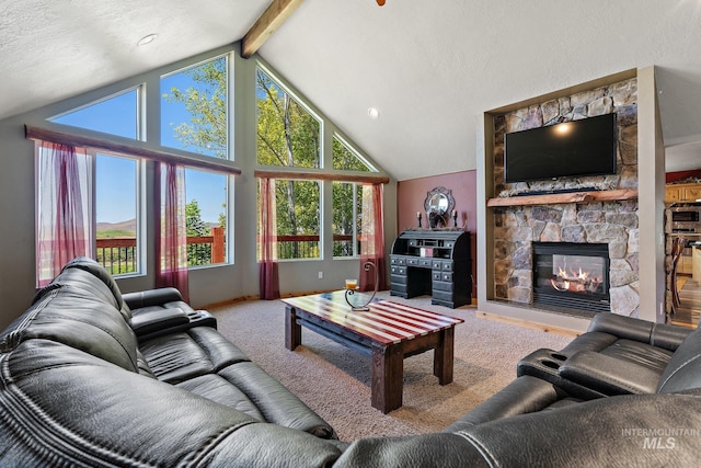 carpeted living room featuring a fireplace, lofted ceiling with beams, and a textured ceiling