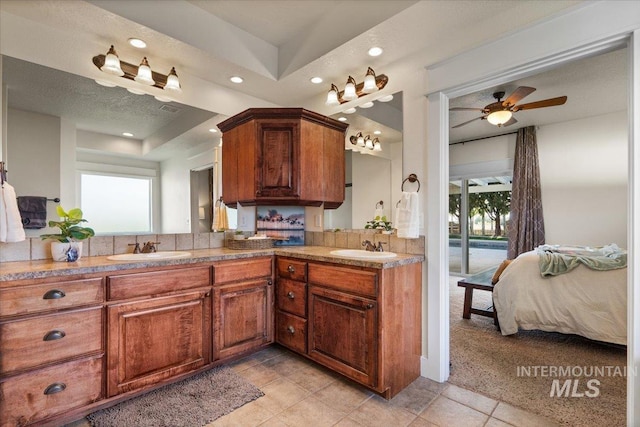 full bathroom with double vanity, ceiling fan, ensuite bath, a sink, and recessed lighting