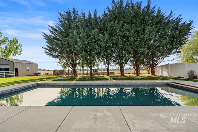 view of pool with a fenced in pool, fence, and a yard