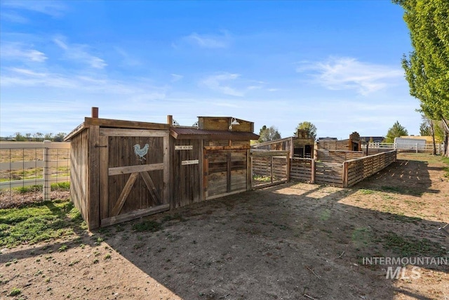 view of gate featuring an outdoor structure