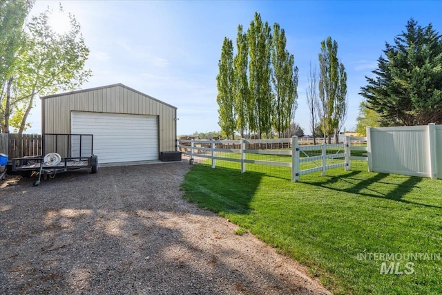 detached garage featuring fence and driveway