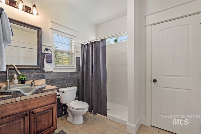 bathroom featuring vanity, tile patterned floors, a stall shower, and toilet