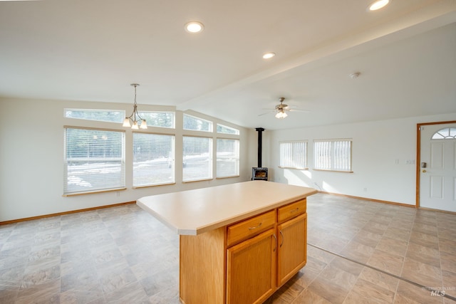 kitchen featuring baseboards, a kitchen island, vaulted ceiling with beams, light countertops, and open floor plan