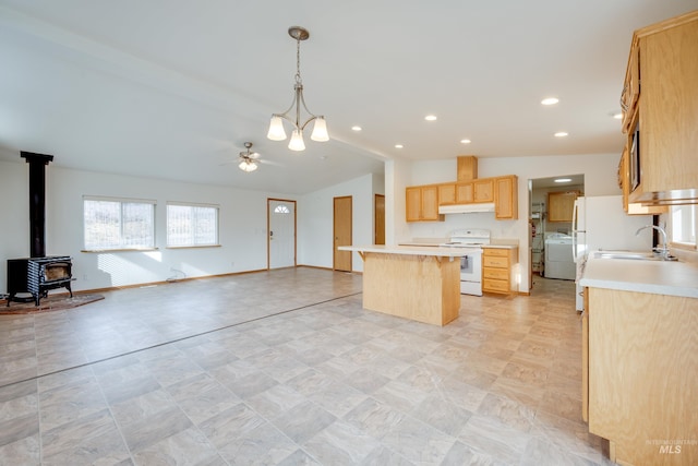 kitchen featuring light brown cabinetry, washer / clothes dryer, open floor plan, a center island, and white electric stove