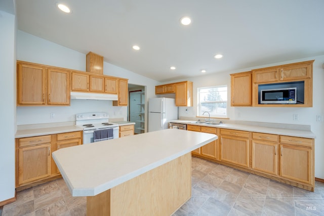 kitchen featuring a sink, light countertops, light brown cabinetry, and stainless steel appliances