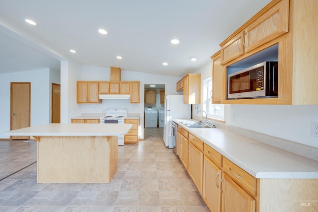 kitchen with light brown cabinets, appliances with stainless steel finishes, under cabinet range hood, and a sink