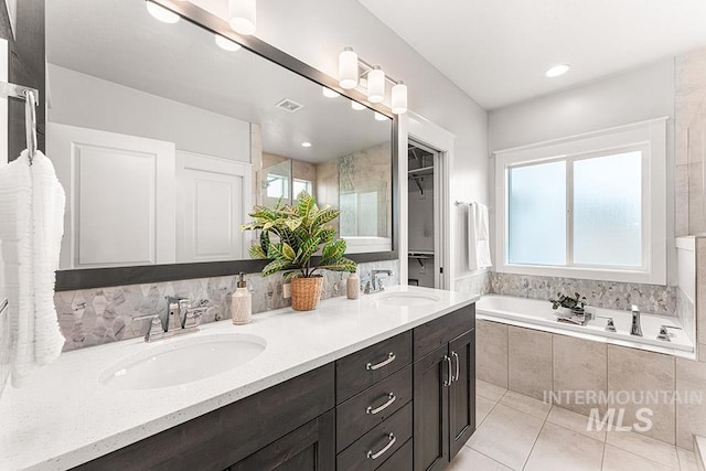 2251 N Garnet Creek Ave, Star, ID 83669 - full bathroom featuring double vanity, a garden tub, and tile patterned flooring