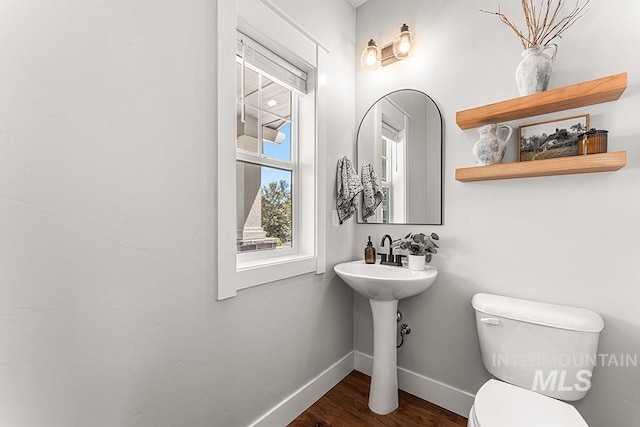 2251 N Garnet Creek Ave, Star, ID 83669 - half bathroom with baseboards, toilet, wood finished floors, and a sink