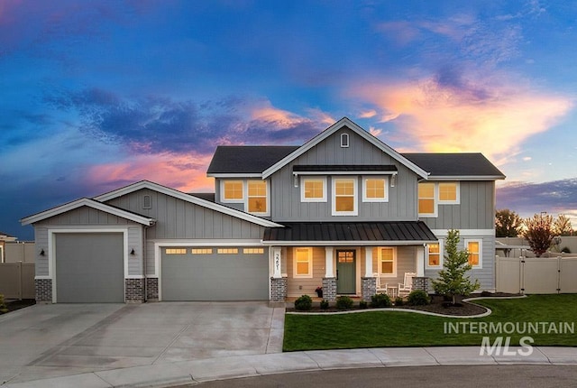 2251 N Garnet Creek Ave, Star, ID 83669 - view of front of home with an attached garage, a porch, driveway, a standing seam roof, and metal roof