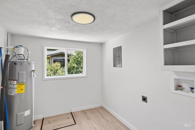 905 E 2nd St, Emmett, ID 83617 - washroom featuring electric water heater, electric dryer hookup, electric panel, a textured ceiling, and wood finished floors