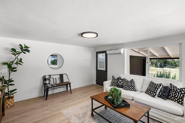 905 E 2nd St, Emmett, ID 83617 - living room featuring a wall unit AC, a textured ceiling, and light wood-type flooring