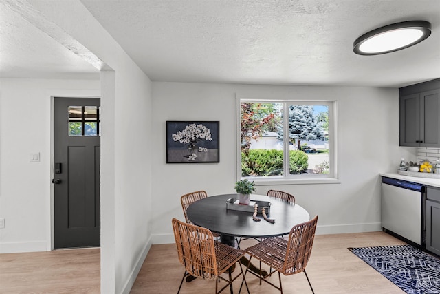 905 E 2nd St, Emmett, ID 83617 - dining room featuring healthy amount of natural light, a textured ceiling, and light wood-style flooring