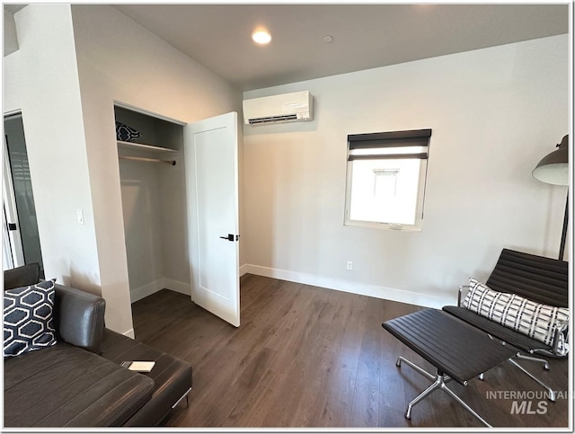 1514 W River St Unit 207, Boise, ID 83702 - sitting room featuring a wall unit AC, wood finished floors, baseboards, and recessed lighting