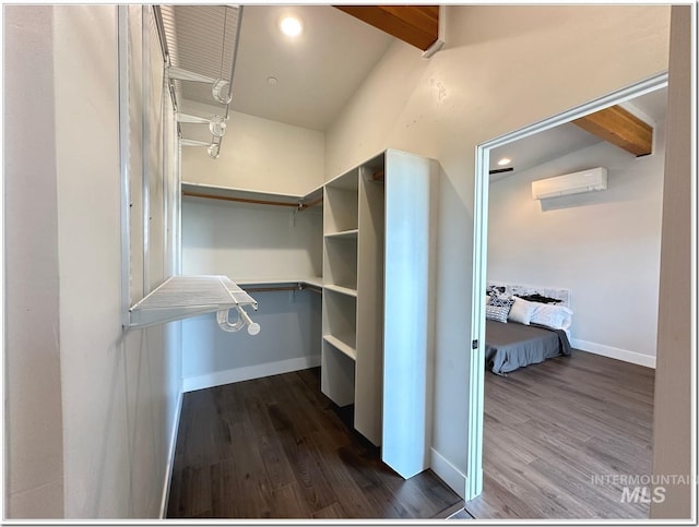 1514 W River St Unit 207, Boise, ID 83702 - walk in closet featuring a wall mounted AC, beam ceiling, and dark wood-style flooring