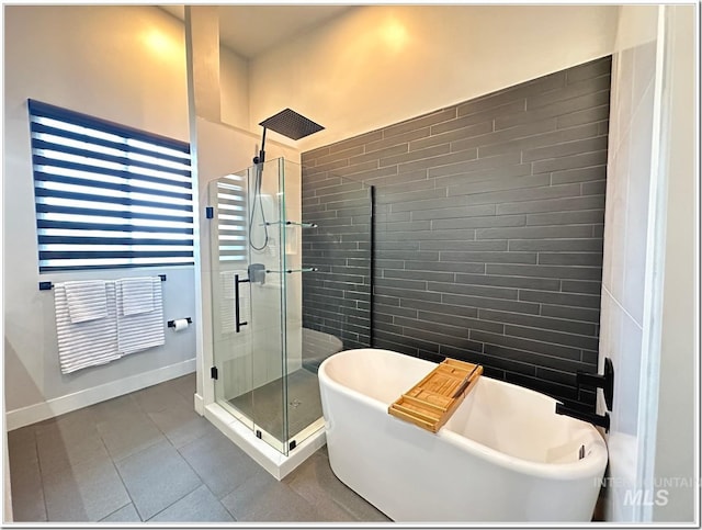 1514 W River St Unit 207, Boise, ID 83702 - full bathroom with a shower stall, a freestanding tub, baseboards, and tile patterned floors