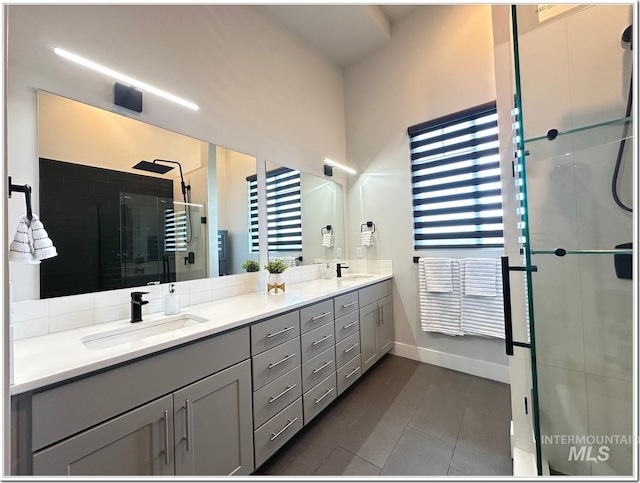 1514 W River St Unit 207, Boise, ID 83702 - bathroom featuring double vanity, a stall shower, tile patterned flooring, and baseboards