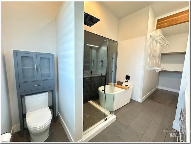 1514 W River St Unit 207, Boise, ID 83702 - bathroom featuring a stall shower, tile patterned flooring, toilet, and baseboards