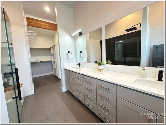 1514 W River St Unit 207, Boise, ID 83702 - bathroom featuring double vanity, a spacious closet, a stall shower, tile patterned floors, and recessed lighting