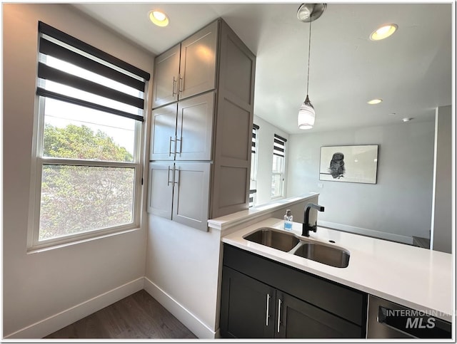 1514 W River St Unit 207, Boise, ID 83702 - kitchen with a sink, baseboards, light countertops, dark wood-style floors, and recessed lighting