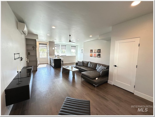 1514 W River St Unit 207, Boise, ID 83702 - living room featuring an AC wall unit, baseboards, dark wood-style flooring, recessed lighting, and a ceiling fan