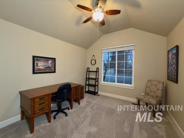 office with ceiling fan, vaulted ceiling, and light carpet